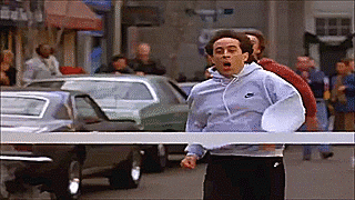 Jerry Seinfeld running through the finish line at a marathon