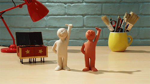 Two figures made out of clay taking a bow. 