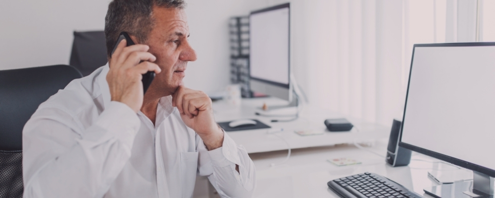 Male senior manager on the phone with a direct report helping to navigate burnout resolution