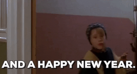 Young boy in a winter hat saying Happy New Year