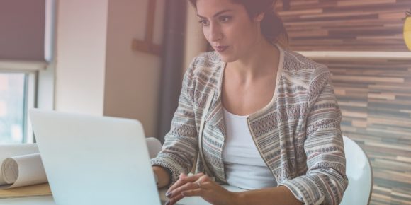 Woman looking concentrated while typing showing she is in deep work