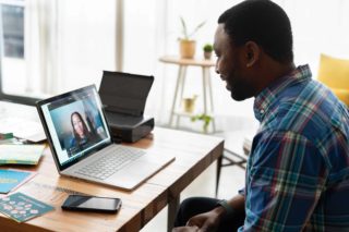 Man having a remote conversation with a team member