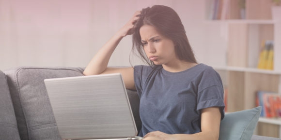 Woman staring at her computer looking very confused at her expectations vs the reality she experienced